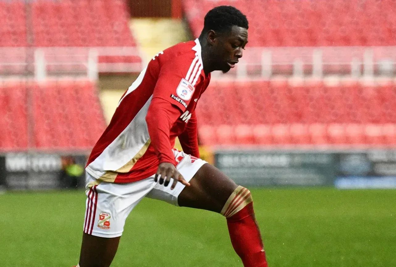 Michael Olakigbe takes on a Barrow defender during a League Two game at the County Ground